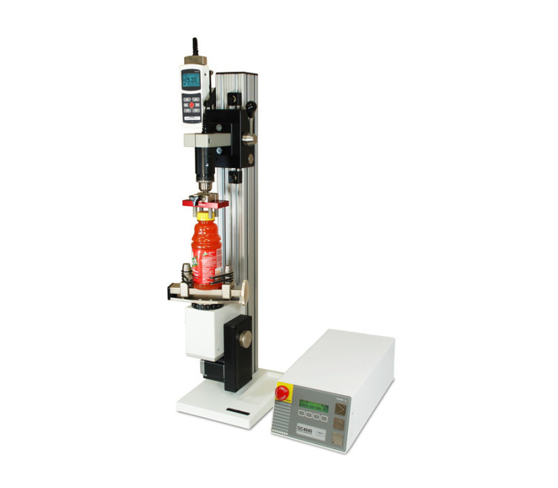 The CAP-TSTM-DC motorized torque test setup, shown in a typical bottle cap torque testing application with M5I force/torque indicator, Series R50 torque sensor, G1023 and G1058 grips.