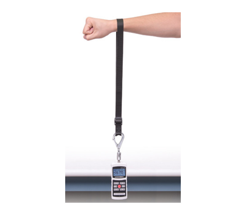 Force gauge mounted on the table top mounting kit with the adjustable length looped strap shown in a vertical orientation.
